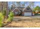 Charming brick home with a well-maintained front yard and attached two-car garage at 8166 N Pine Cone Dr, Villa Rica, GA 30180