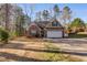 Charming brick home with a well-maintained front yard and attached two-car garage at 8166 N Pine Cone Dr, Villa Rica, GA 30180