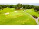 Overhead view of the lush green golf course, featuring sand traps and manicured fairways at 8166 N Pine Cone Dr, Villa Rica, GA 30180