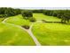 Lush golf course featuring manicured fairways and walking paths for a premier golfing experience at 8166 N Pine Cone Dr, Villa Rica, GA 30180