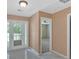 Neutral hallway featuring tile floors and access to additional rooms, including the living room at 8166 N Pine Cone Dr, Villa Rica, GA 30180