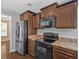 A kitchen with stainless steel appliances, granite counter tops, and dark wood cabinets at 8166 N Pine Cone Dr, Villa Rica, GA 30180