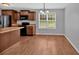 A kitchen and dining area with stainless steel appliances and dark wood cabinets at 8166 N Pine Cone Dr, Villa Rica, GA 30180