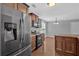 A kitchen with stainless steel appliances, a dining area, dark wood cabinets, and wood floors at 8166 N Pine Cone Dr, Villa Rica, GA 30180