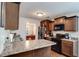 Well-lit kitchen featuring brown cabinets, granite countertops, and modern appliances at 8166 N Pine Cone Dr, Villa Rica, GA 30180