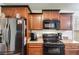 Kitchen appliances including a stainless steel refrigerator and black microwave and oven at 8166 N Pine Cone Dr, Villa Rica, GA 30180
