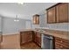 Galley style kitchen featuring stainless steel appliances, dark wood cabinetry, and solid surface countertops at 8166 N Pine Cone Dr, Villa Rica, GA 30180
