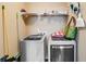 Laundry room with modern washing machines and storage shelf above machines at 8166 N Pine Cone Dr, Villa Rica, GA 30180