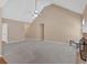 A spacious living room with a vaulted ceiling, brick fireplace, and a view into the dining room at 8166 N Pine Cone Dr, Villa Rica, GA 30180