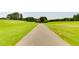 Winding asphalt path in the golf course for a calm walk, run, or golf cart ride at 8166 N Pine Cone Dr, Villa Rica, GA 30180
