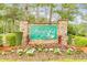 Welcoming entrance to Fairfield Plantation with colorful flowers and manicured landscaping at 8166 N Pine Cone Dr, Villa Rica, GA 30180
