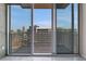 Balcony with city view through sliding glass doors with white frames and light tile floor at 855 Peachtree Ne St # 2812, Atlanta, GA 30308