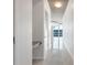 Modern hallway with sleek tile flooring, white walls, and a glimpse of the exterior through glass doors at 855 Peachtree Ne St # 2812, Atlanta, GA 30308