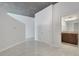 Bright hallway leading to a bathroom with a vanity and tiled shower and tub at 855 Peachtree Ne St # 2812, Atlanta, GA 30308