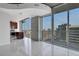 Open-concept living space with bright tile flooring, floor-to-ceiling windows, and city views at 855 Peachtree Ne St # 2812, Atlanta, GA 30308