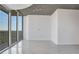 Spacious and modern living area with sleek tile flooring, floor-to-ceiling windows, and balcony access at 855 Peachtree Ne St # 2812, Atlanta, GA 30308