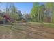Expansive backyard with lush grass, playset, and surrounding trees at 241 Rose Ridge Dr, Canton, GA 30115