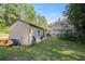 View of a shed in the backyard, showing the back exterior elevation of the home behind it at 241 Rose Ridge Dr, Canton, GA 30115