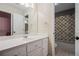 Bathroom featuring a large vanity with a white marble countertop, framed mirror, and a shower/tub combo at 241 Rose Ridge Dr, Canton, GA 30115