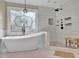 Beautiful bathroom with a soaking tub, walk-in shower, and stylish tile work at 241 Rose Ridge Dr, Canton, GA 30115
