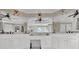 Well-lit bathroom featuring dual sinks, white cabinetry, and decorative fixtures at 241 Rose Ridge Dr, Canton, GA 30115