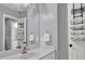 Well-lit bathroom featuring a white vanity, large mirror and a towel rack on the door at 241 Rose Ridge Dr, Canton, GA 30115