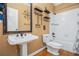 Traditional bathroom with pedestal sink, wood floors, and shower-tub combination at 241 Rose Ridge Dr, Canton, GA 30115