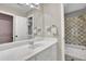 Hall bathroom featuring a single sink vanity and tub shower at 241 Rose Ridge Dr, Canton, GA 30115