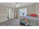 Comfortable bedroom with natural light, carpeted floors, and neutral paint at 241 Rose Ridge Dr, Canton, GA 30115