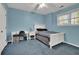 Cozy bedroom with blue walls, natural light, and a comfortable sleeping and study area at 241 Rose Ridge Dr, Canton, GA 30115