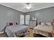 Inviting bedroom with two twin beds, hardwood floors, and neutral wall paint at 241 Rose Ridge Dr, Canton, GA 30115