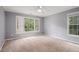 Spacious bedroom features neutral carpet, light gray walls, ceiling fan, and a window overlooking the front yard at 241 Rose Ridge Dr, Canton, GA 30115
