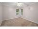 Bright and airy bedroom with carpet flooring, neutral walls, and natural light from two windows at 241 Rose Ridge Dr, Canton, GA 30115