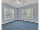 Spacious bedroom with blue carpet and two large windows providing ample natural light at 241 Rose Ridge Dr, Canton, GA 30115