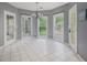 Breakfast nook featuring tile flooring, chandelier, three windows, and door leading to a deck at 241 Rose Ridge Dr, Canton, GA 30115