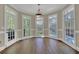 Bright breakfast nook features hardwood floors, a modern light fixture, and large windows with a view of the backyard and pool at 241 Rose Ridge Dr, Canton, GA 30115