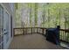 Wood deck showcasing a grill and offering views of the surrounding trees at 241 Rose Ridge Dr, Canton, GA 30115