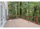 A spacious wooden deck offers serene outdoor space with views of the lush surrounding greenery at 241 Rose Ridge Dr, Canton, GA 30115