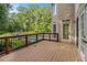 An elevated deck overlooks a beautiful backyard, with a view of the swimming pool and mature trees at 241 Rose Ridge Dr, Canton, GA 30115
