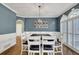 Elegant dining room featuring wainscoting, modern chandelier, and views of staircase at 241 Rose Ridge Dr, Canton, GA 30115