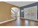 Welcoming foyer with hardwood floors, staircase, and natural light shining through the front door at 241 Rose Ridge Dr, Canton, GA 30115