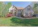 Charming two-story home featuring stone accents, a manicured lawn and mature landscaping at 241 Rose Ridge Dr, Canton, GA 30115