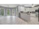 Bright kitchen with white cabinets, tile floors, breakfast bar, and backyard view at 241 Rose Ridge Dr, Canton, GA 30115