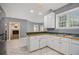 Spacious kitchen with a view into the living room, featuring white cabinets at 241 Rose Ridge Dr, Canton, GA 30115