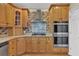 Well-equipped kitchen with stainless steel appliances, wooden cabinets, and tile backsplash at 241 Rose Ridge Dr, Canton, GA 30115