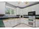 Bright kitchen featuring white cabinetry, green countertops, and modern appliances at 241 Rose Ridge Dr, Canton, GA 30115