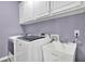 Functional laundry room with modern washer, dryer, sink, and ample cabinet space at 241 Rose Ridge Dr, Canton, GA 30115
