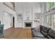 Bright living room with fireplace, hardwood floors, custom built-ins, and soaring ceilings with large windows at 241 Rose Ridge Dr, Canton, GA 30115