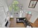Bright living room with fireplace, hardwood floors, custom built-ins, and soaring ceilings with large windows at 241 Rose Ridge Dr, Canton, GA 30115