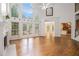 Light-filled living room with hardwood floors, tall windows, and views to the backyard at 241 Rose Ridge Dr, Canton, GA 30115
